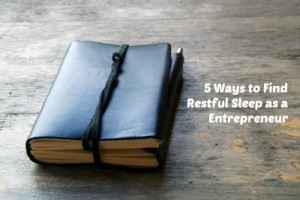 5 Ways to Find Restful Sleep as a Entrepreneur, A leather bound journal sits on a table outside with a cord wrapped around the pages to keep place in book.